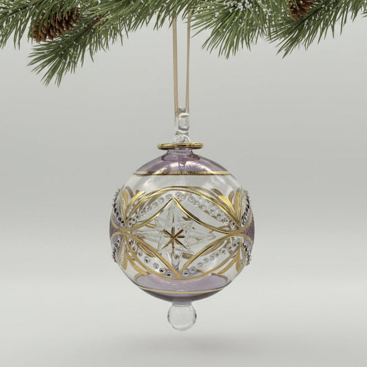 Handblown glass ornament with  carousel and stars design with tops hand painted in lavender and with gold highlights