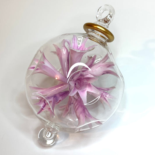 Hand-blown glass ornament with lilac floral design