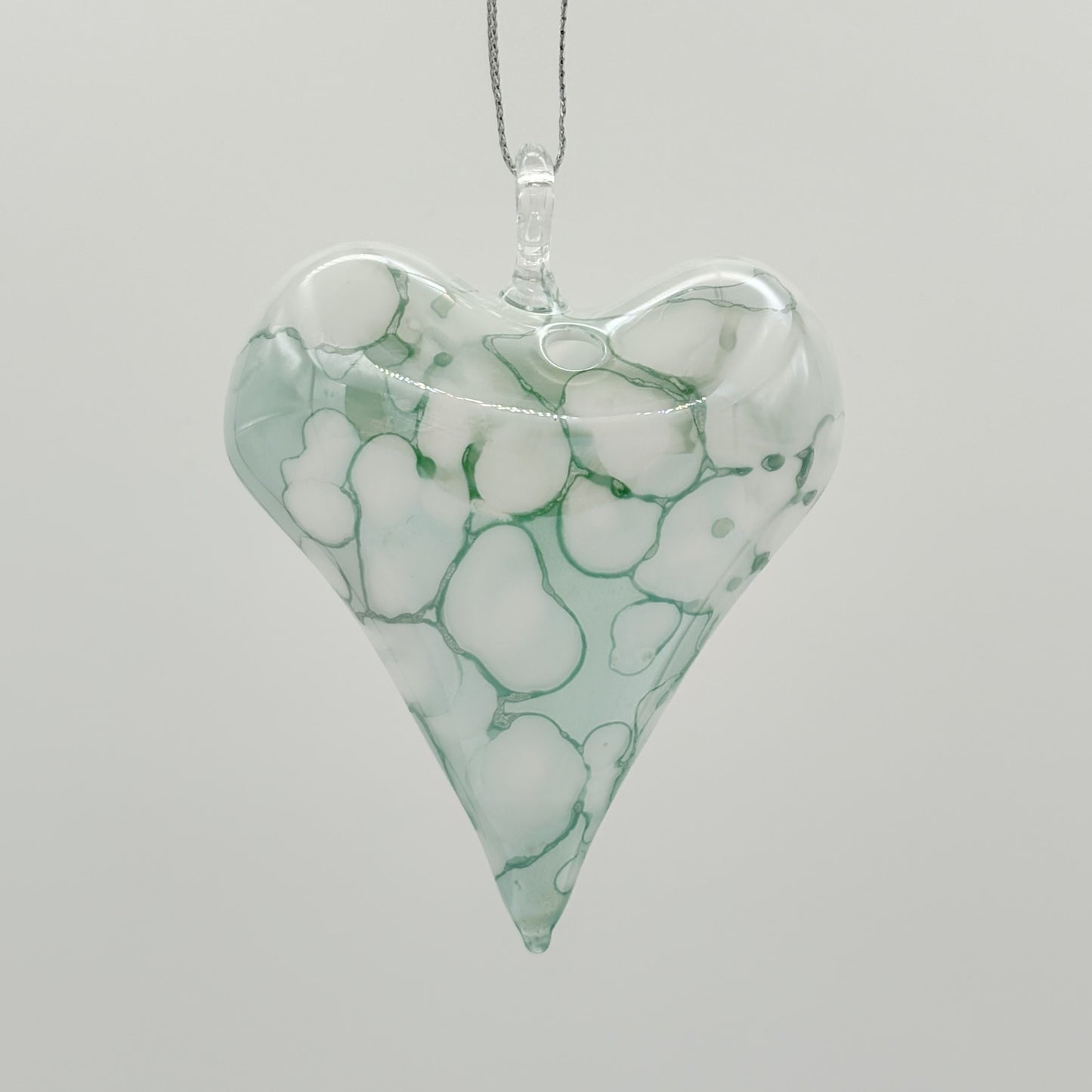 Heart-shaped ornament with green and white marbled pattern