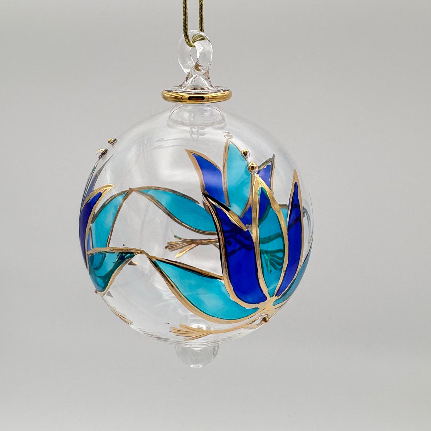 Fair trade handblown glass ornament with blue and turquoise colored lotus and gold detail, ethically handmade