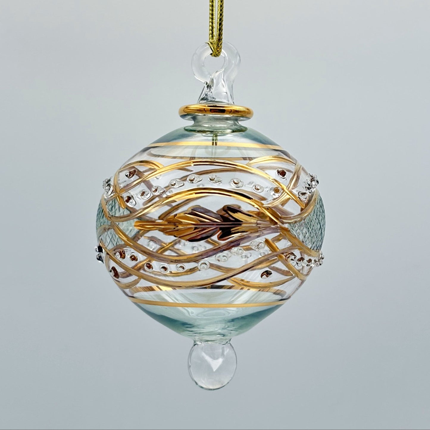 Decorative handblown glass Christmas ornaments with intricate designs and gold hilghlights