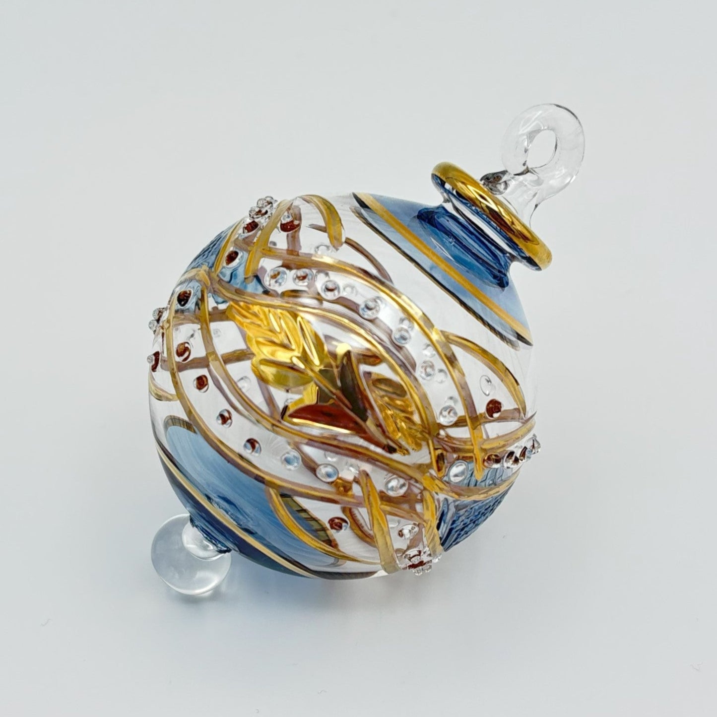 Decorative handblown glass Christmas ornaments with intricate designs and gold hilghlights