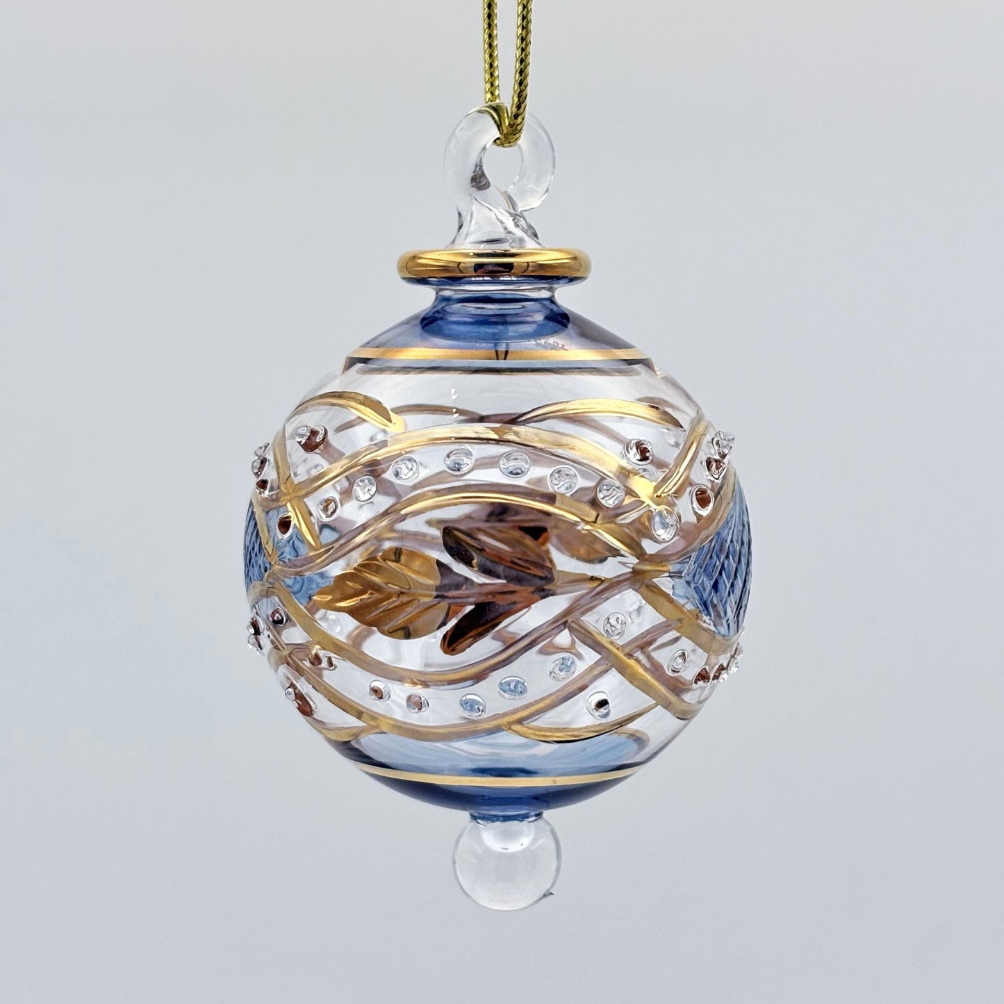 Decorative handblown glass Christmas ornaments with intricate designs and gold hilghlights