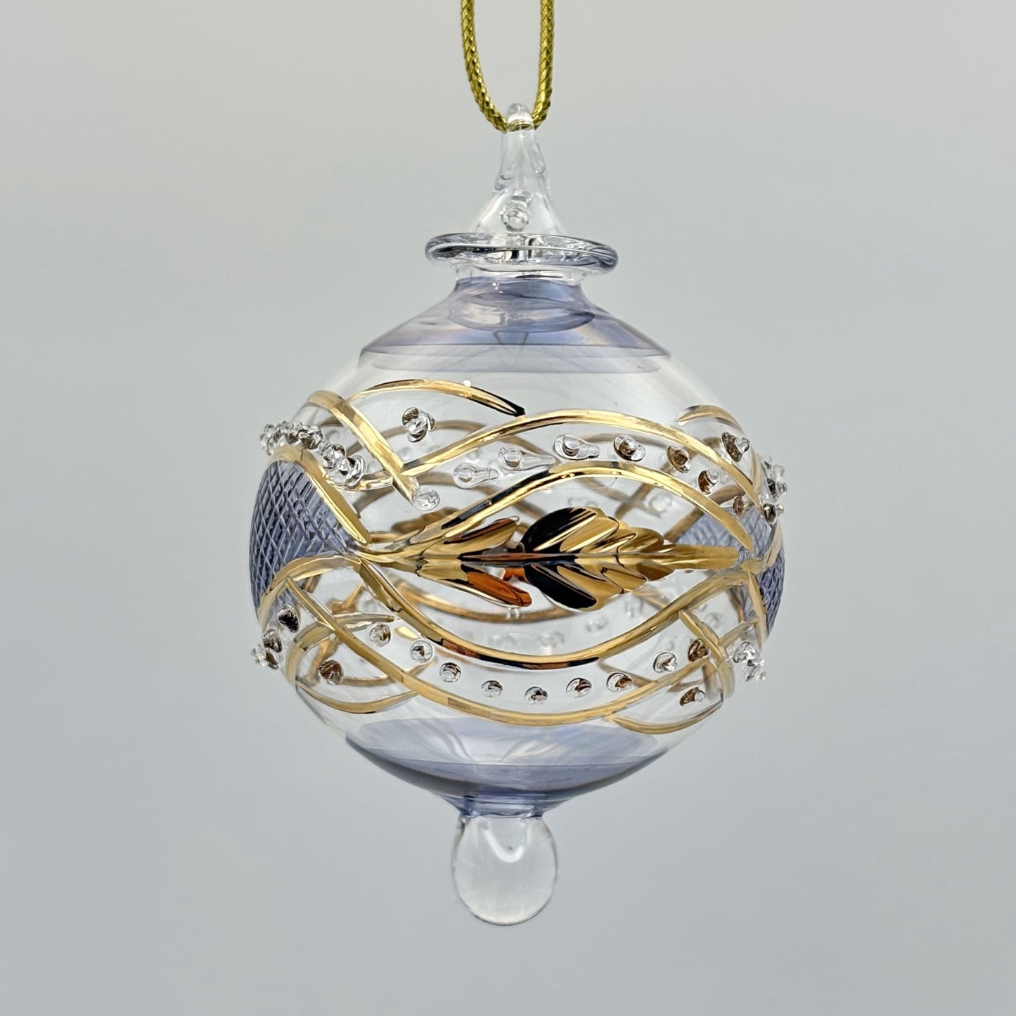 Decorative handblown glass Christmas ornaments with intricate designs and gold hilghlights