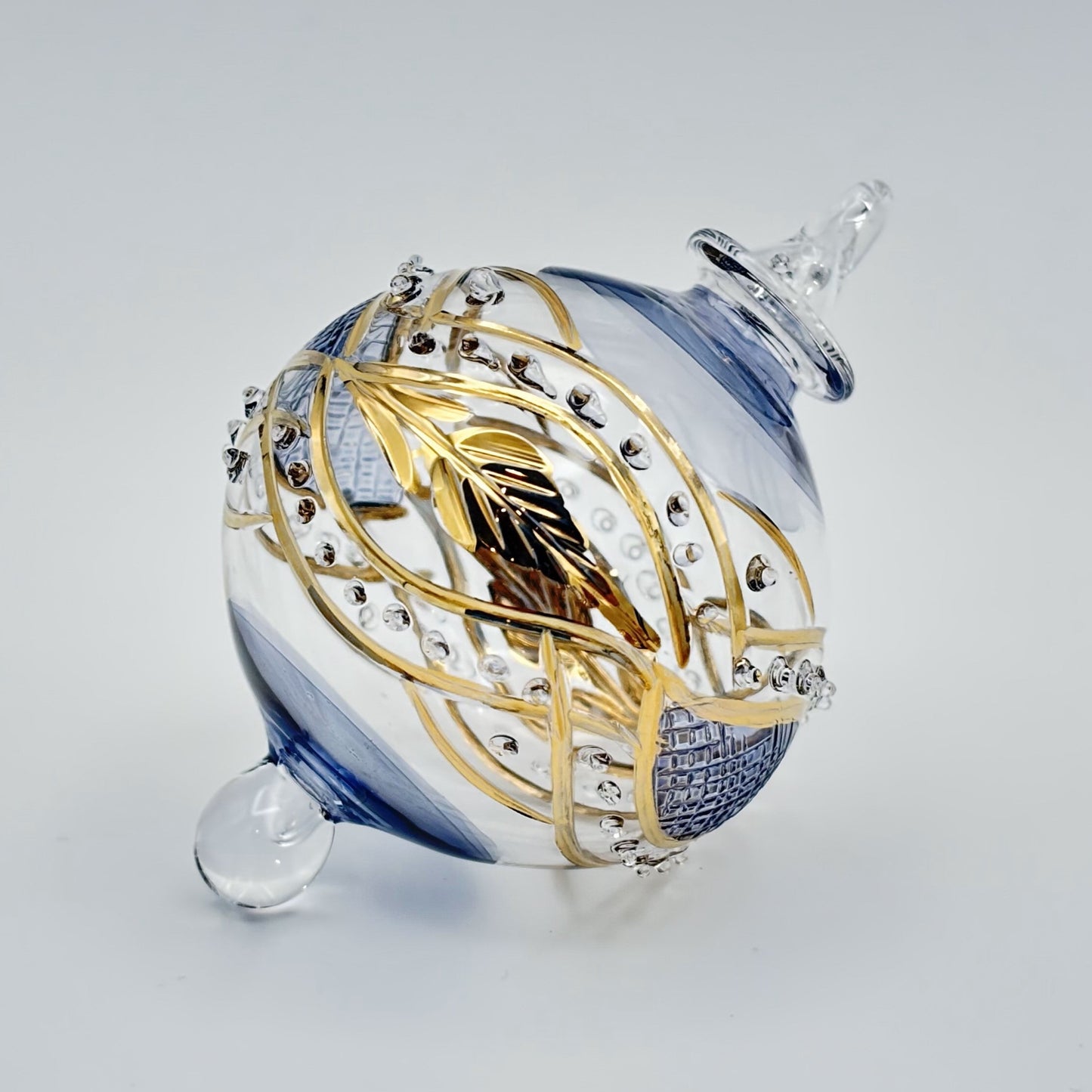 Decorative handblown glass Christmas ornaments with intricate designs and gold hilghlights