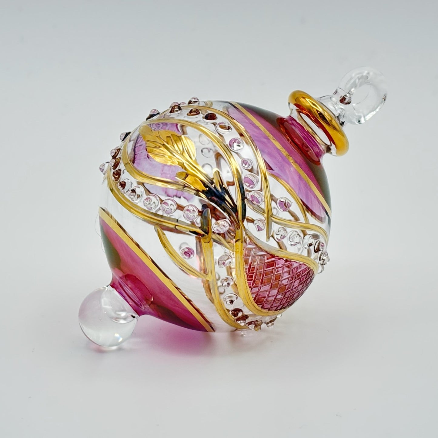 Decorative handblown glass Christmas ornaments with intricate designs and gold hilghlights