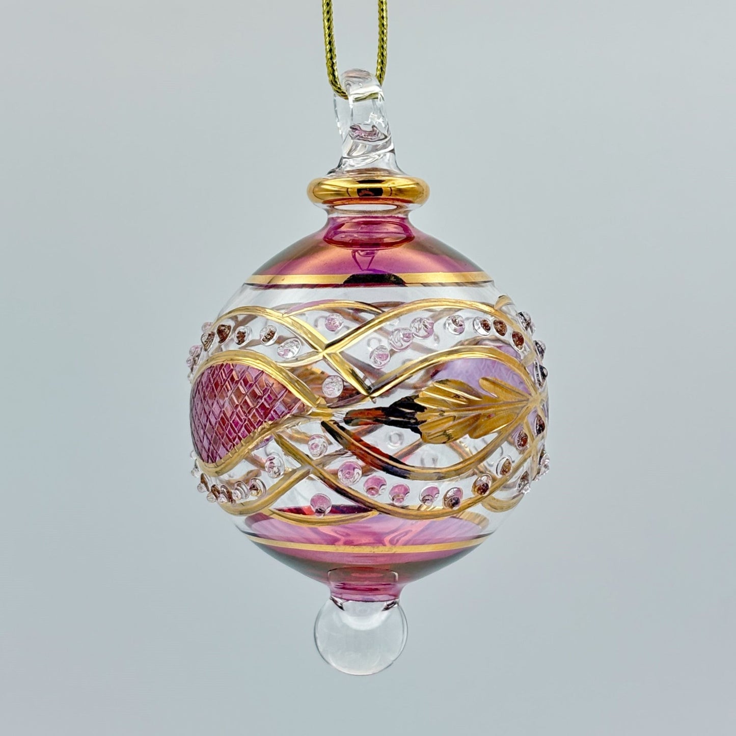 Decorative handblown glass Christmas ornaments with intricate designs and gold hilghlights