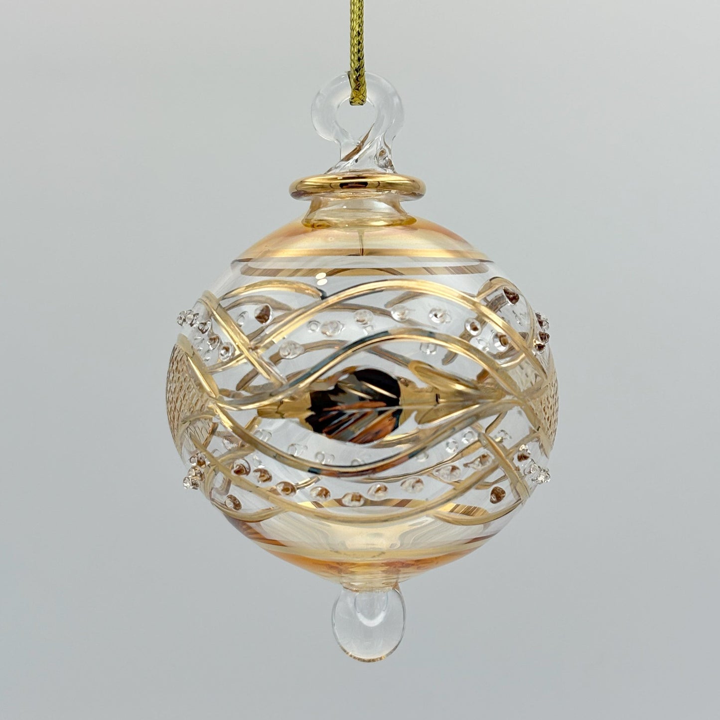 Decorative handblown glass Christmas ornaments with intricate designs and gold hilghlights