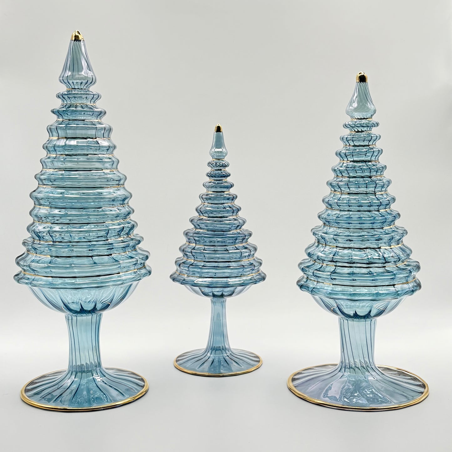 Ethically handcrafted handblown glass Christmas trees in iridescent light blue wiht hand painted gold higlights