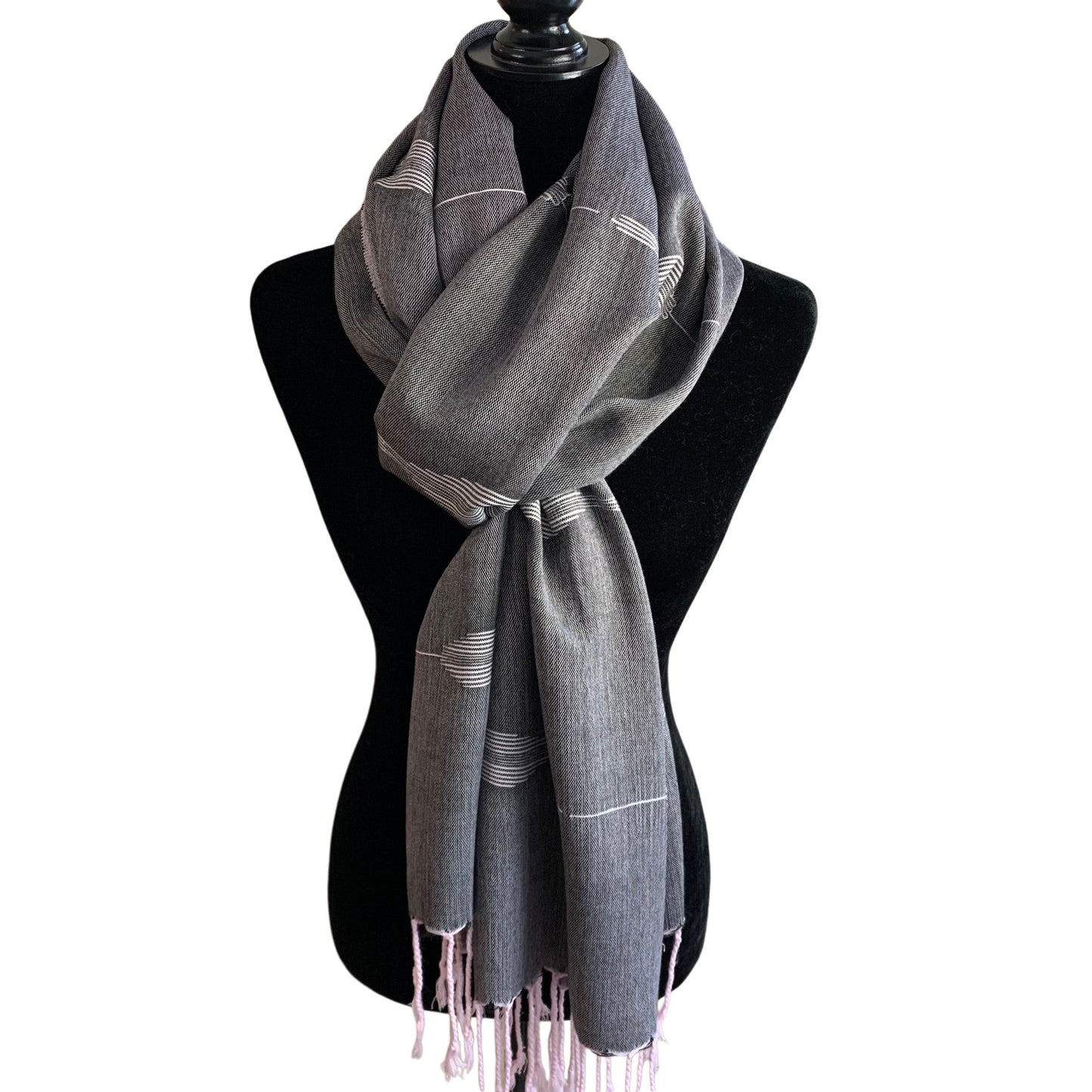 Fair trade handwoven gray scarf with white feather patterns and pink fringes