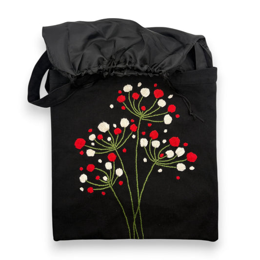 Black tote bag with hand-embroidered floral pattern with red and white berries