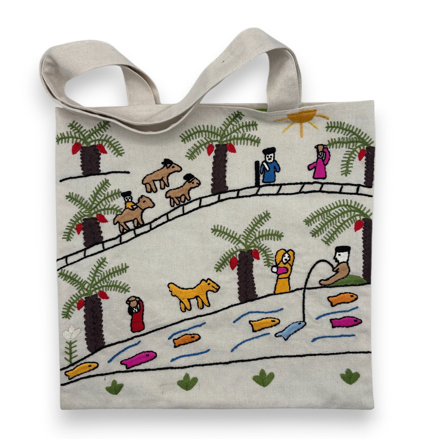 Off-white canvas tote bag with hand-embroidered design of people and animals on the bank of the Nile river