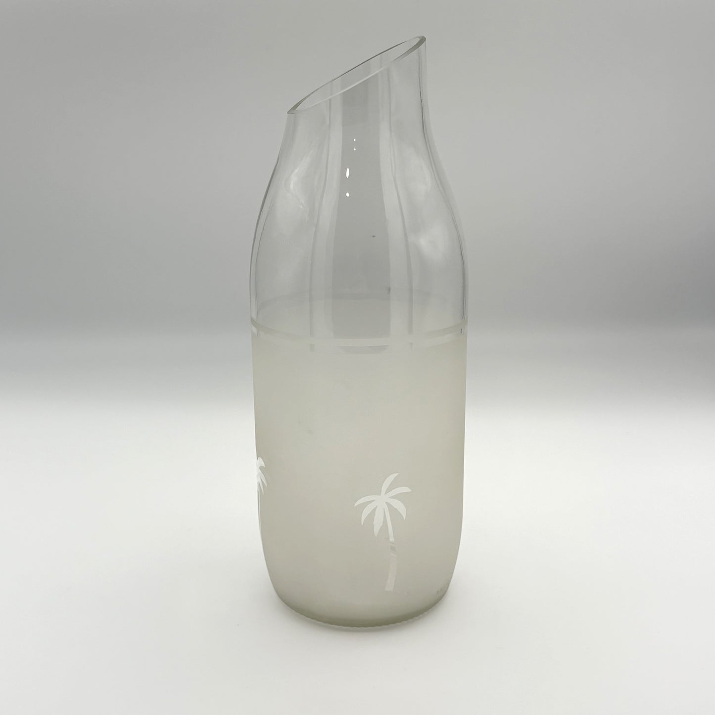 Upcycled glass jug vase with palms decoration