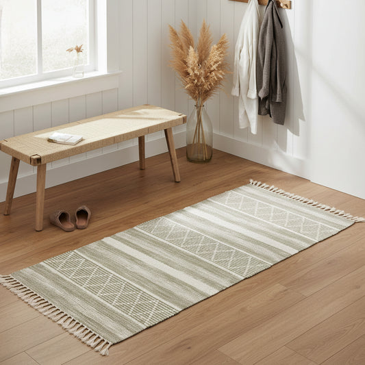 Handwoven rectangular kilim rug with a geometric diamond pattern, and alternating bands of natural beige and off-white, finished with fringed edges.