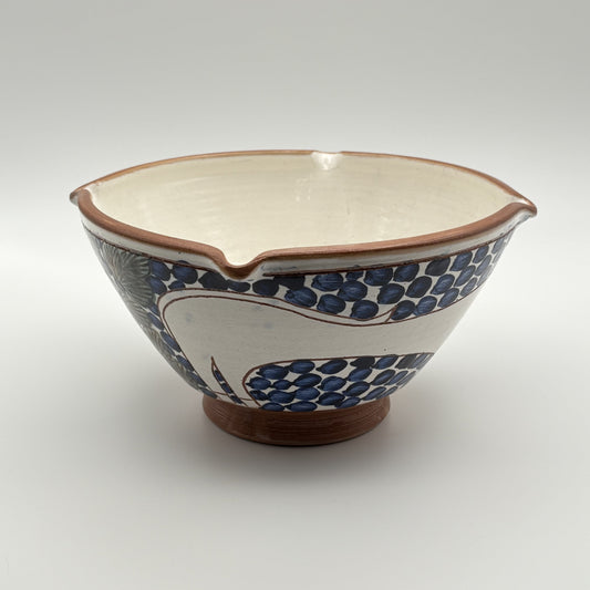 Handcrafted fair trade ceramic bowl with bouncing cat on a blue and white floral design
