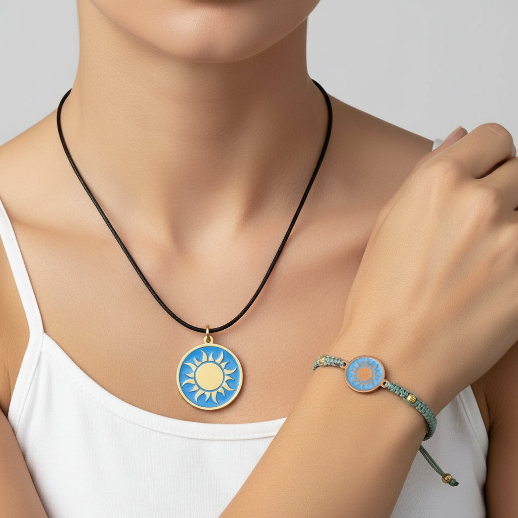 Teal macrame bracelet with a brass medallion featuring a gold sun emblem on turquoise enamel and matching pendant on black cord, fair trade handmade