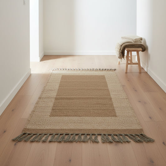Rectangular handwoven wool kilim runner in neutral hues; brown center panel, beige striped border, and dark gray fringe on both ends, fair trade handmade