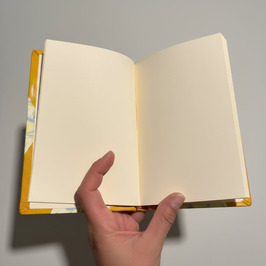 Handmade notebook journal with marbled paper cover and mustard leather corners