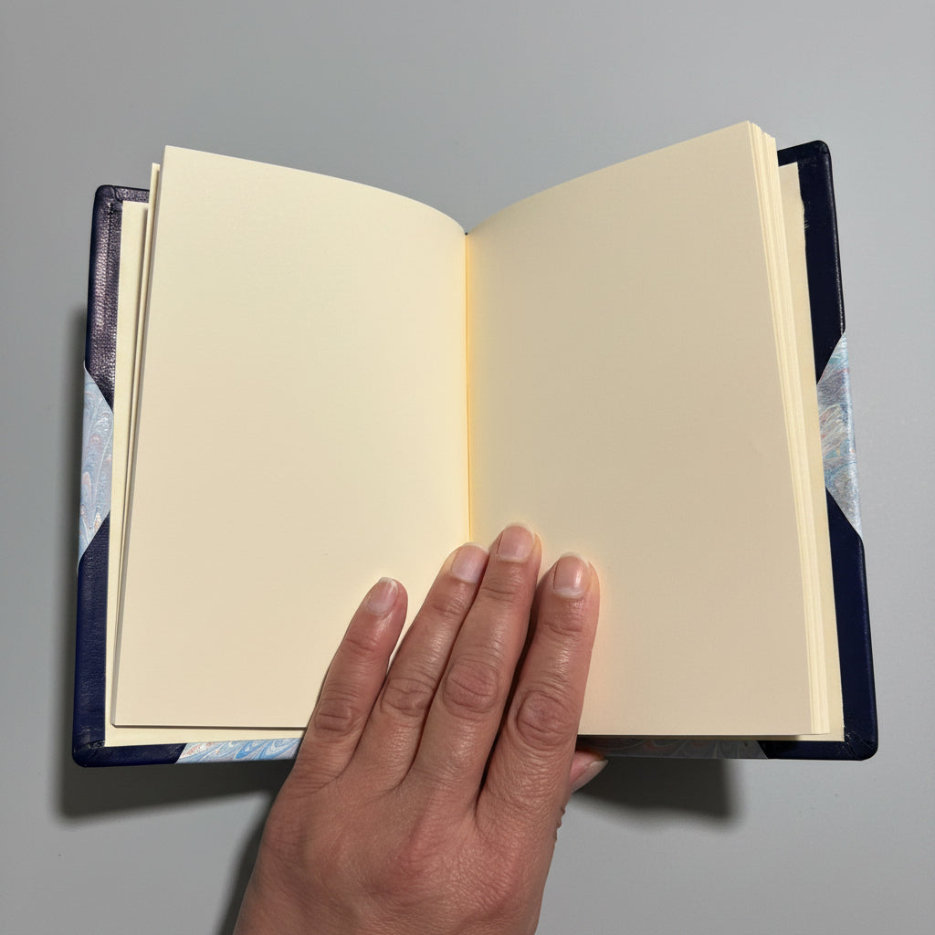 Handbound notebook journal with marbled cover and dark blue leather spine and corners, fair trade