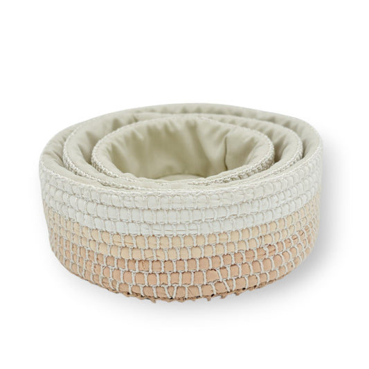 Set of three neutral colored upcycled textile crochet baskets with textured surfaces