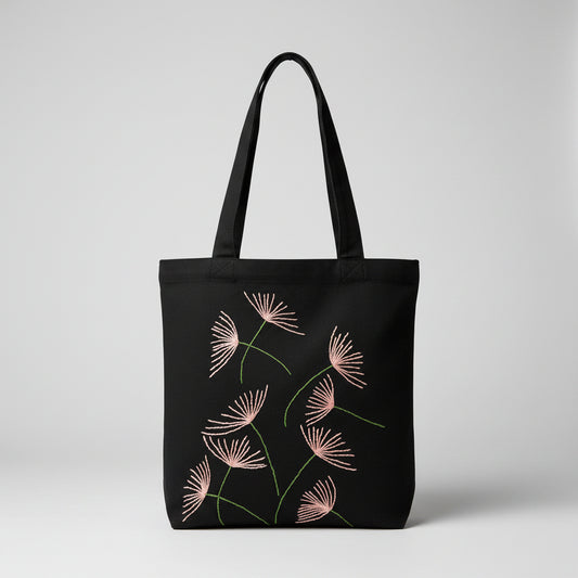 Black canvas tote bag with hand-embroidered pink papyrus design, fair trade handmade