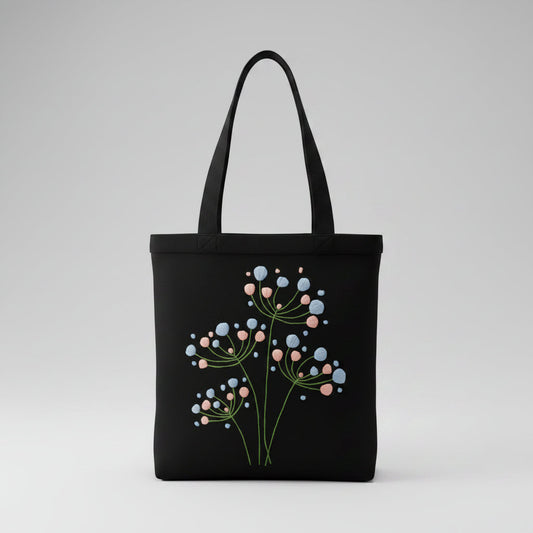 Handmade black tote bag with hand-embroidered light blue and pink hydrangea, fair trade