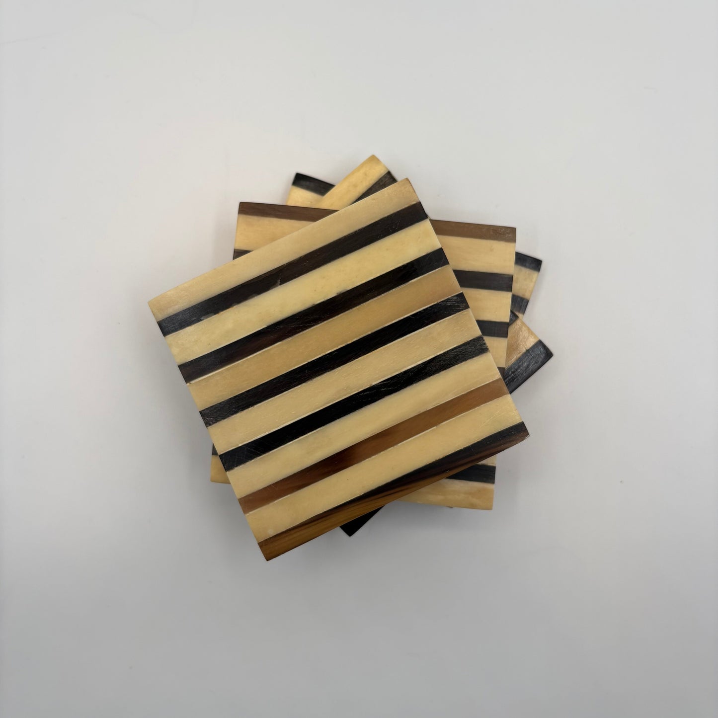 Set of 4 wooden coasters inlaid with camel bone with dark brown and beige stripe pattern, fair trade