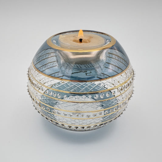 Fair trade handblown glass candle holder with intricate patterns, gold detail and blue rim, ethically handmade