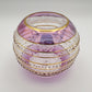 Fair trade handblown glass candle holder with intricate patterns, gold detail and pink rim, ethically handmade