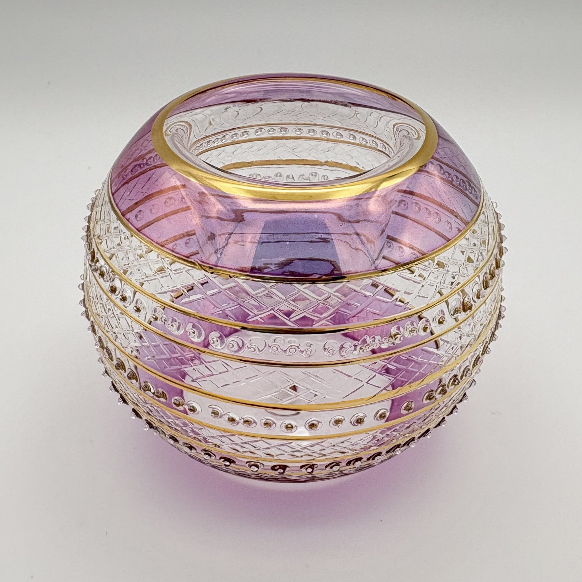 Fair trade handblown glass candle holder with intricate patterns, gold detail and pink rim, ethically handmade