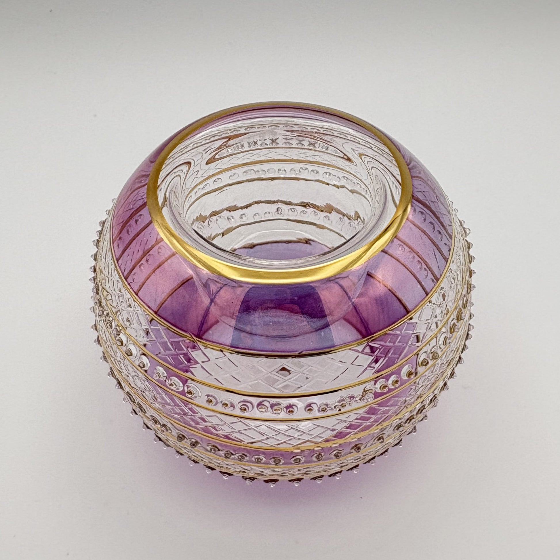 Fair trade handblown glass candle holder with intricate patterns, gold detail and pink rim, ethically handmade