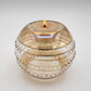 Fair trade handblown glass candle holder with intricate patterns, gold detail and yellow rim, ethically handmade