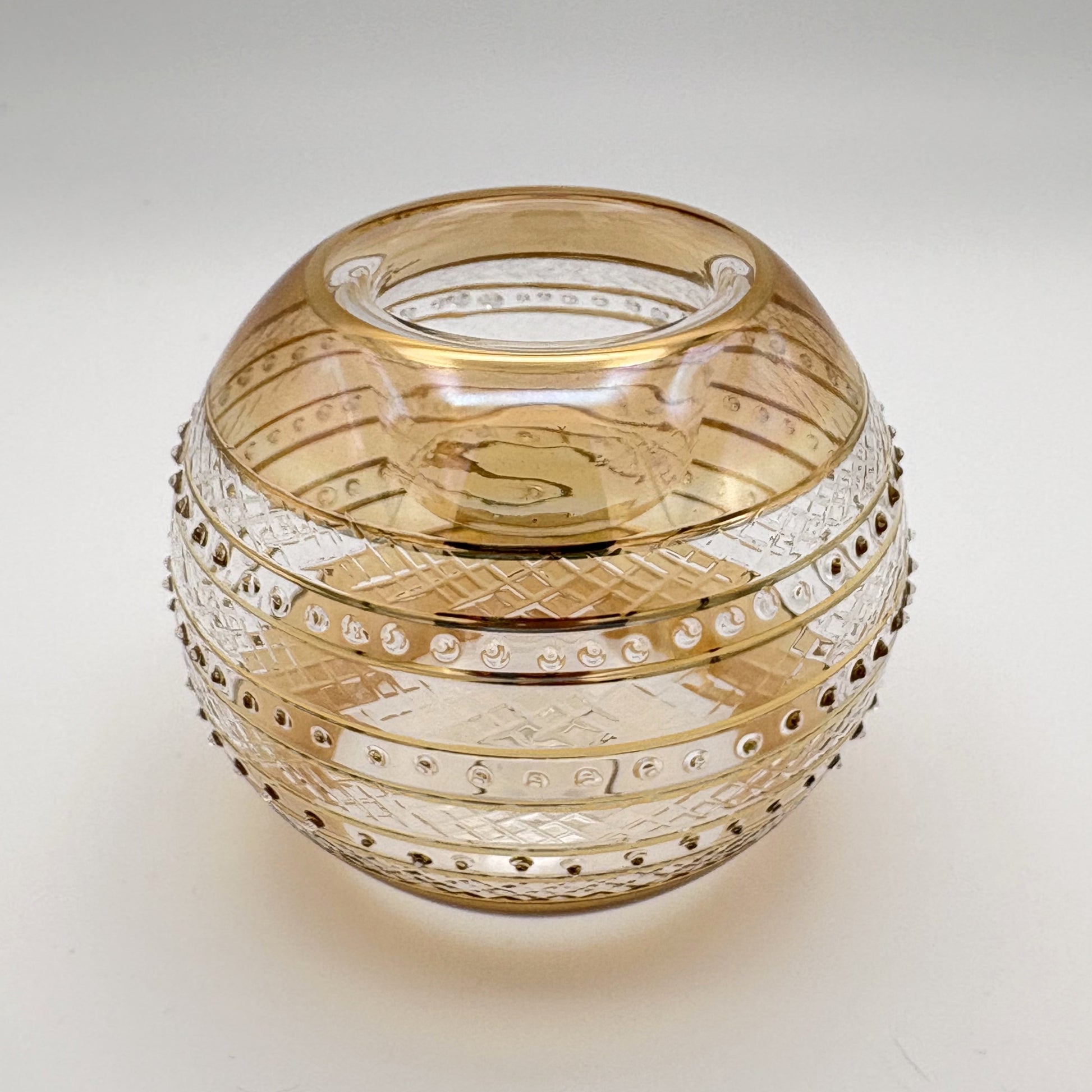 Fair trade handblown glass candle holder with intricate patterns, gold detail and yellow rim, ethically handmade