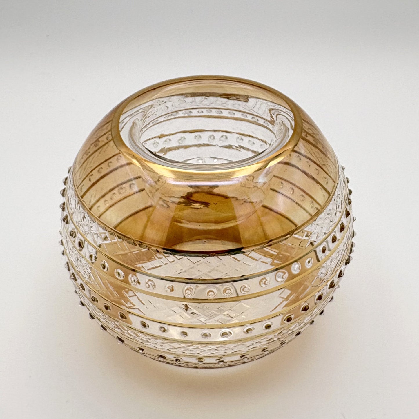 Fair trade handblown glass candle holder with intricate patterns, gold detail and yellow rim, ethically handmade