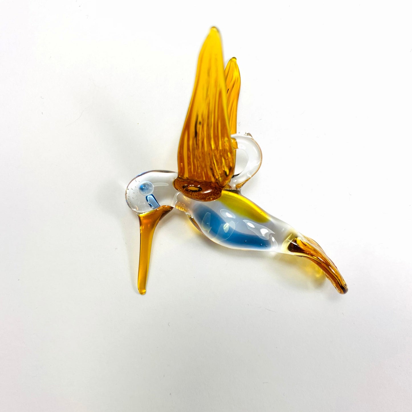 Amber-colored bird-shaped handmade glass ornament