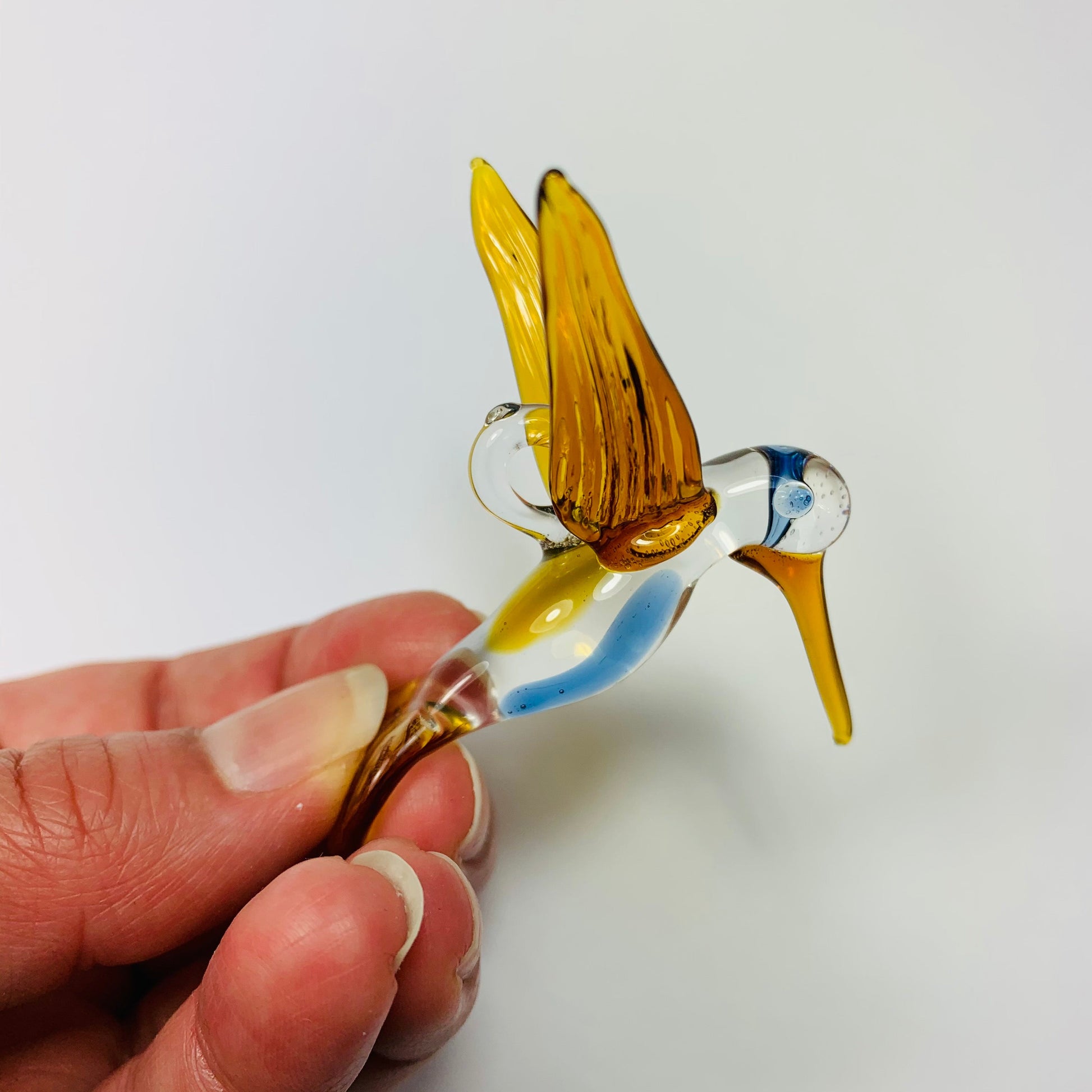 Fair trade artisanal handmade glass hummingbird in amber, ethically handcrafted