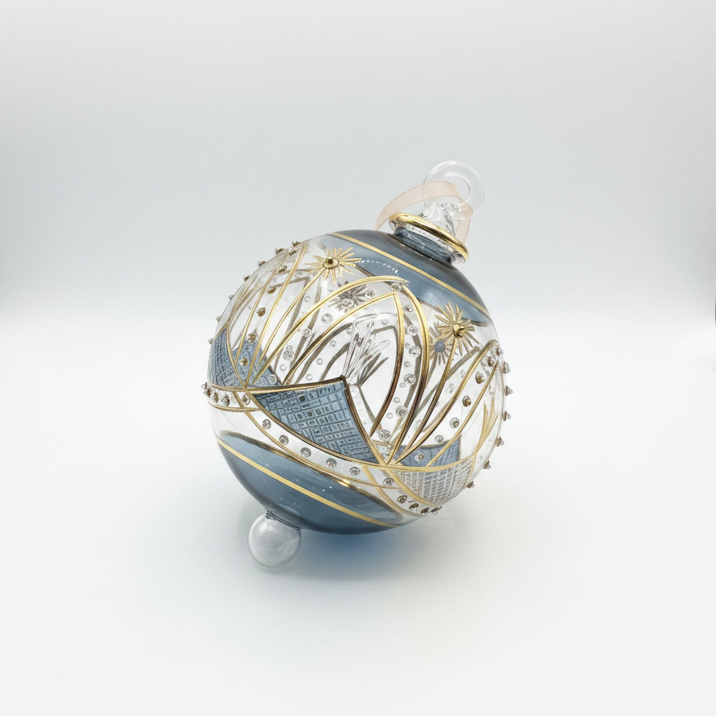 Hand-blown glass bauble ornament with a blue and gold painted design