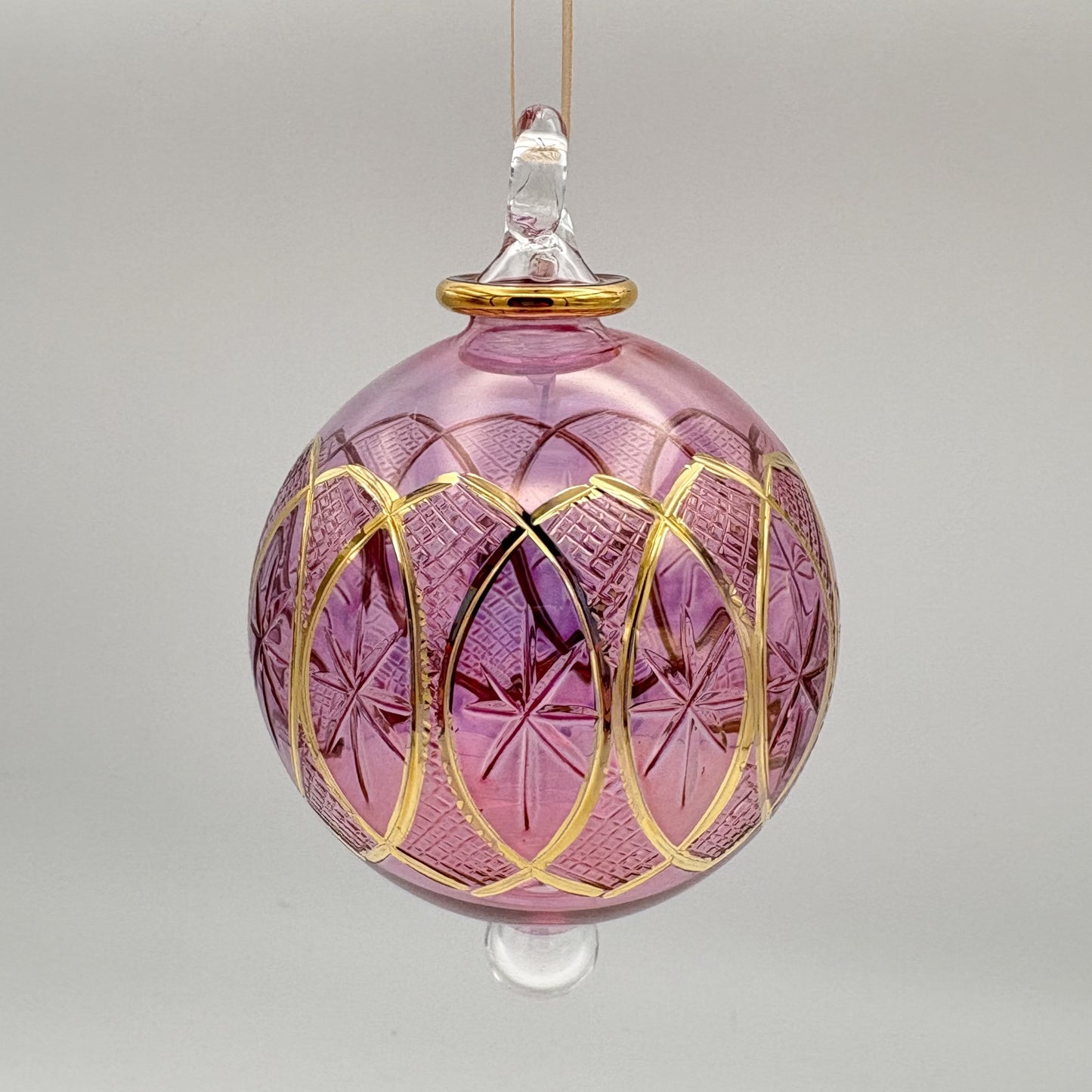 Fair trade handblown glass pink ornament with stars and lozenges etched pattern and gold detail, ethically handmade