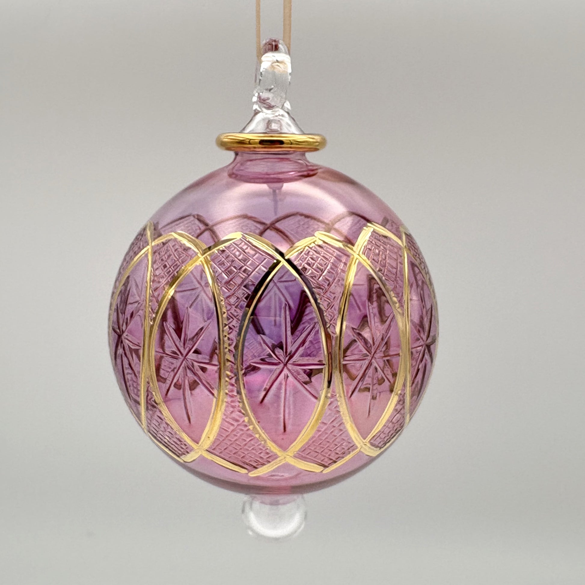 Fair trade handblown glass pink ornament with stars and lozenges etched pattern and gold detail, ethically handmade