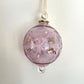 Blown glass bauble ornament with a pink tint and gold detail, featuring etched flowers