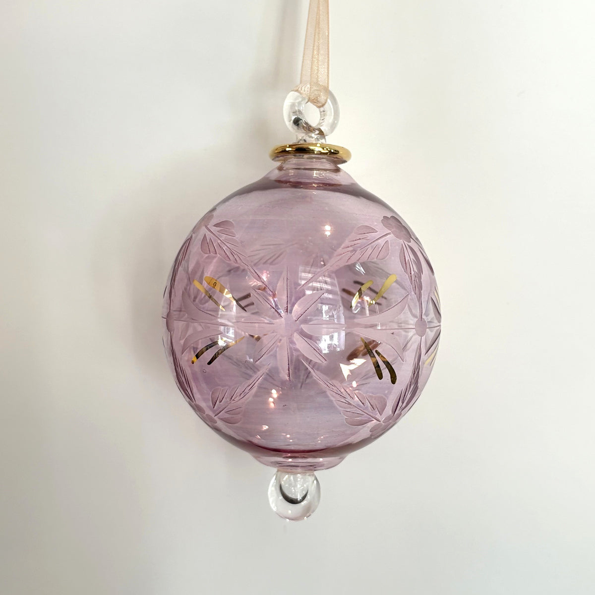 Blown glass bauble ornament with a pink tint and gold detail, featuring etched flowers