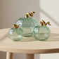 Ethically fair trade green handblown glass pumpkins with gold stems 