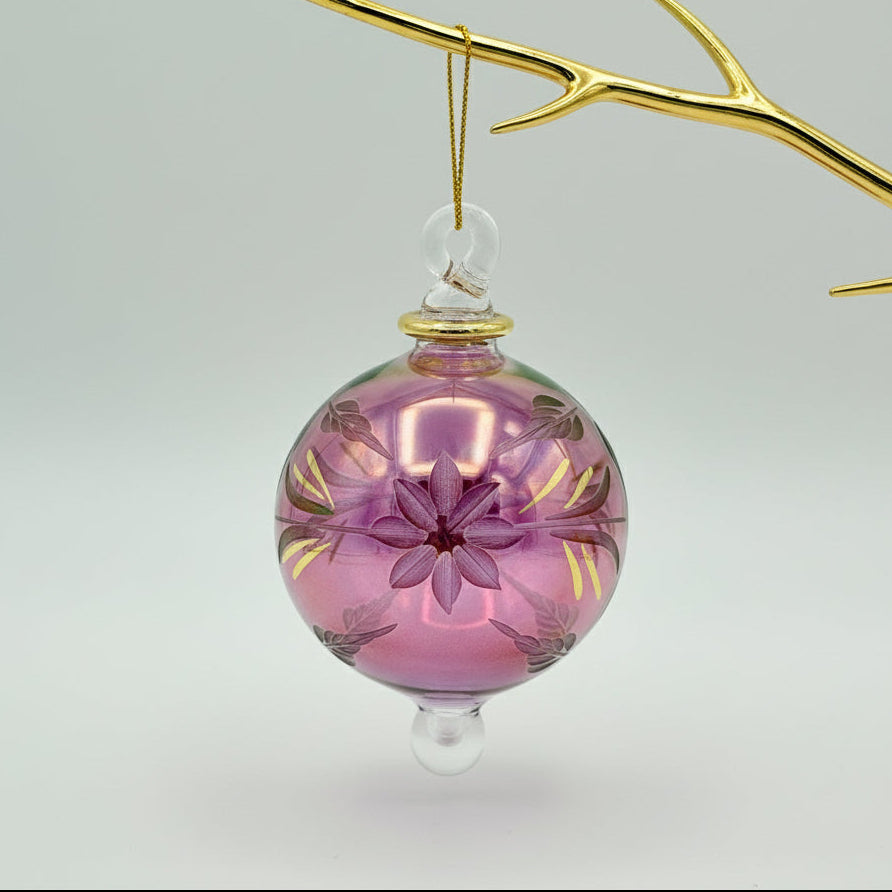 Fair Trade magenta handblown glass ornament with etched gold floral patterns 