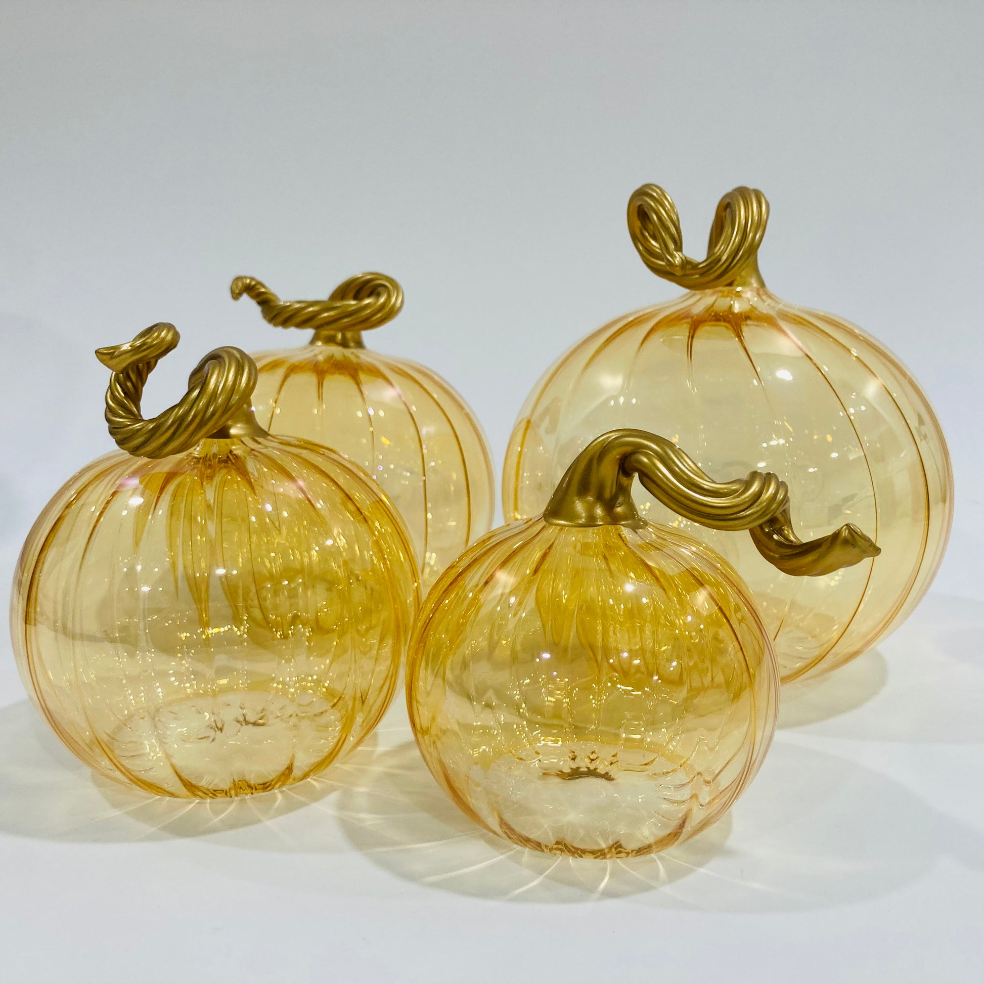 Hand-blown glass iridescent amber pumpkins with gold stems