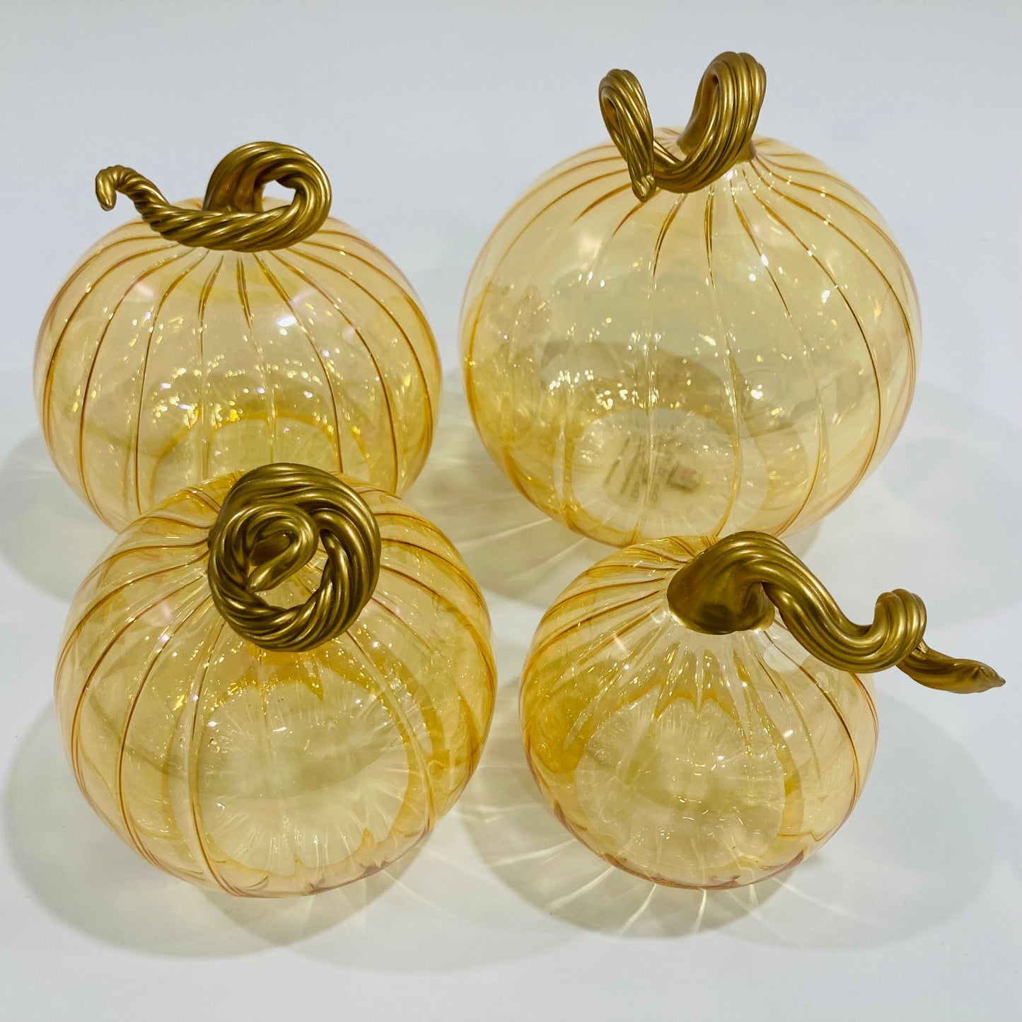 Hand-blown glass iridescent amber pumpkins with gold stems