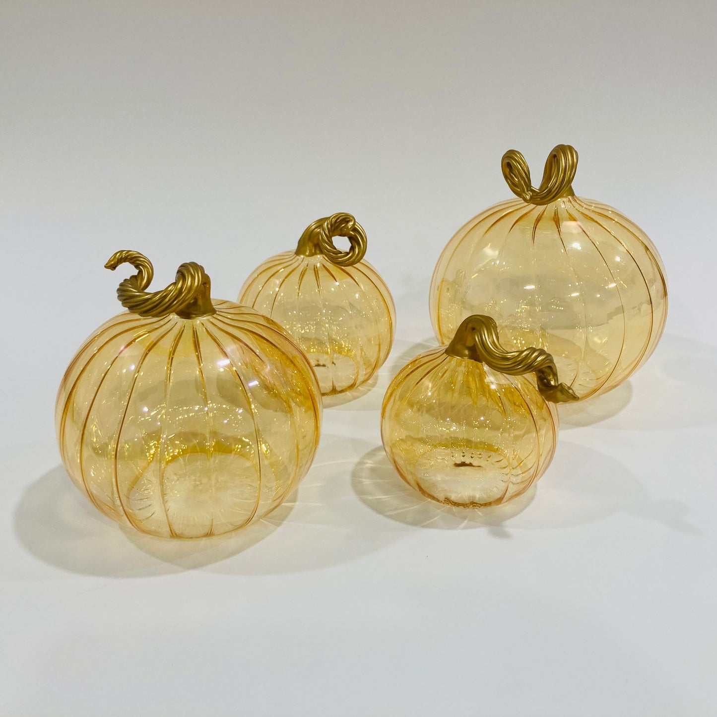 Hand-blown glass iridescent amber pumpkins with gold stems