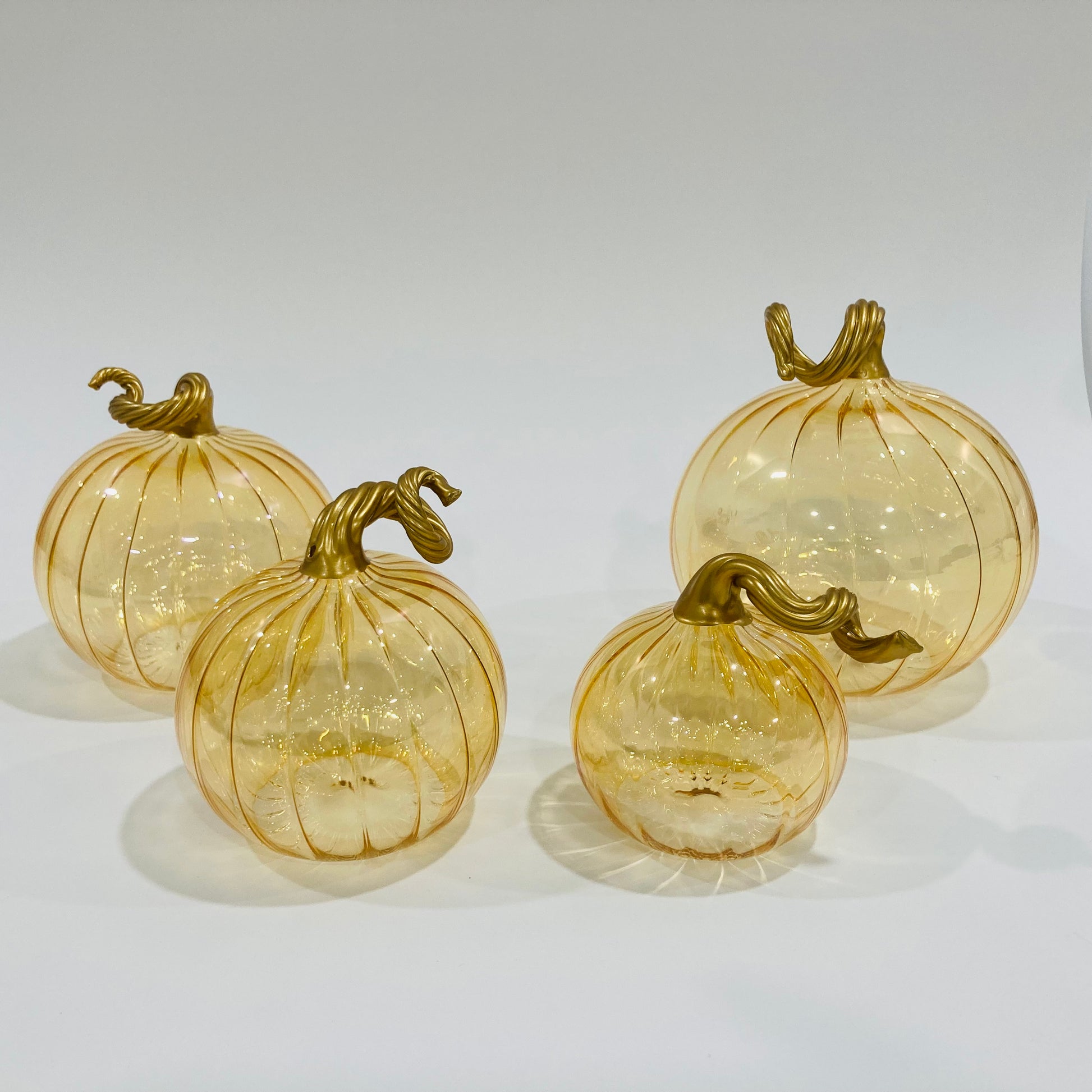 Hand-blown glass iridescent amber pumpkins with gold stems