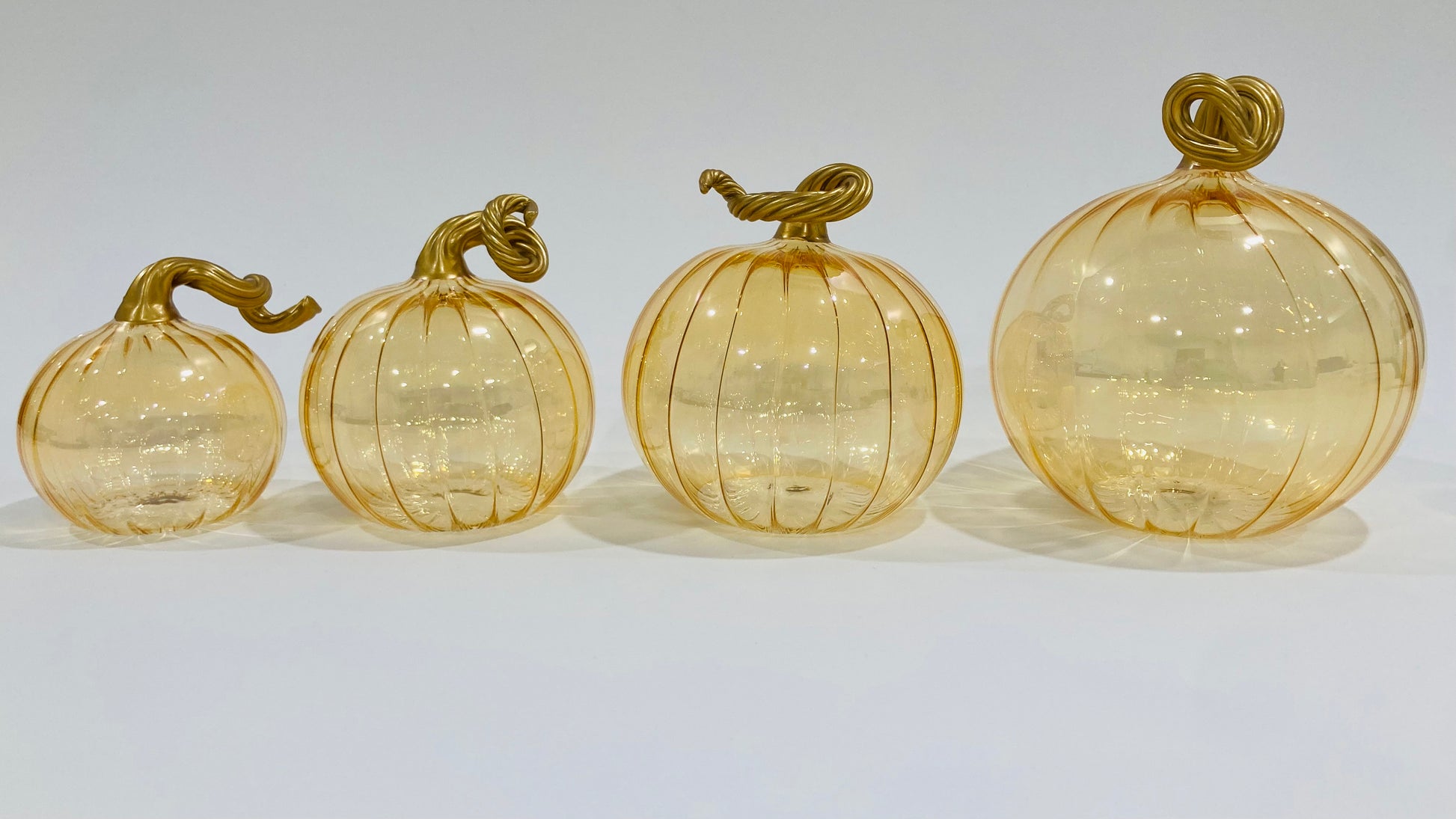Hand-blown glass iridescent amber pumpkins with gold stems