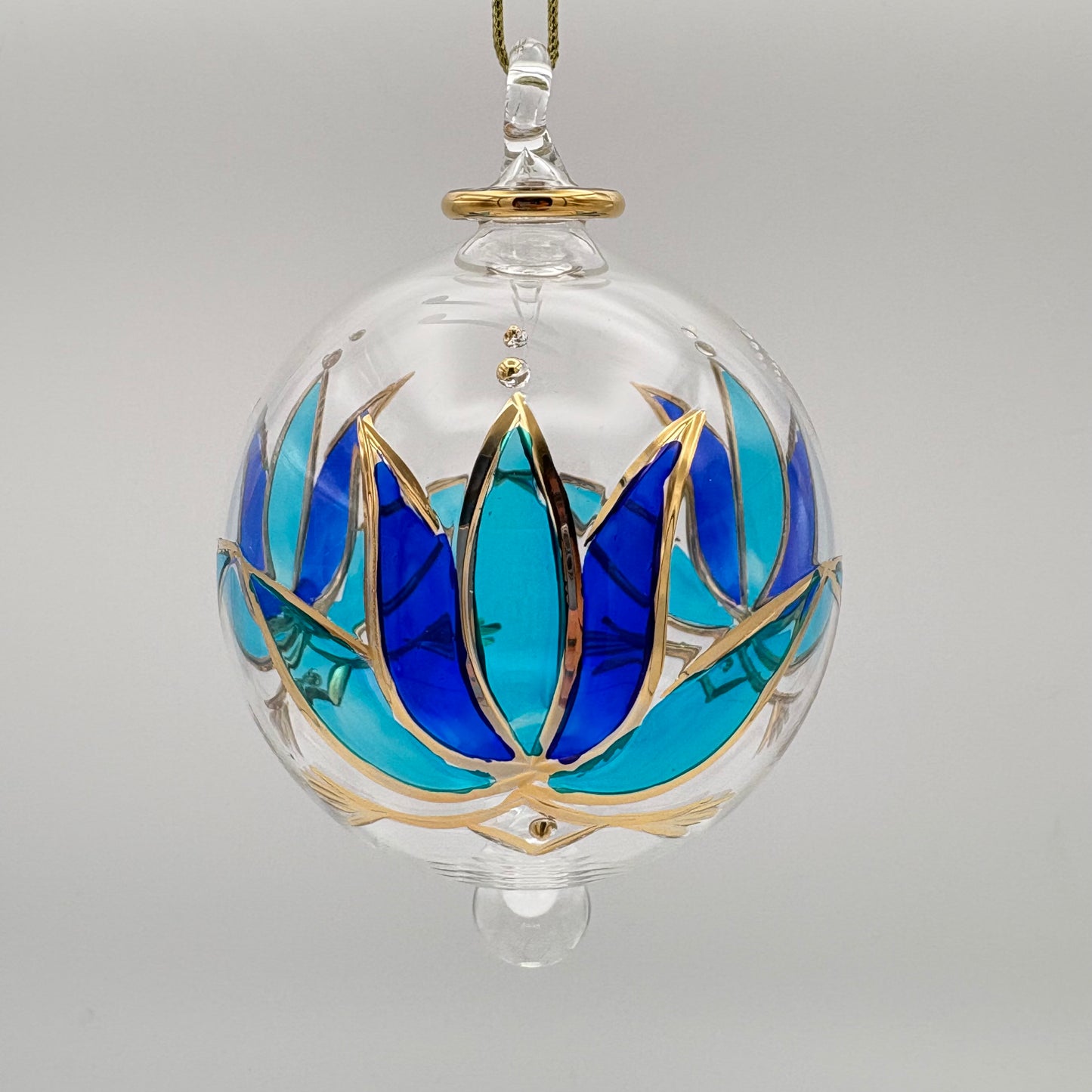 Fair trade handblown glass ornament with blue and turquoise colored lotus and gold detail, ethically handmade