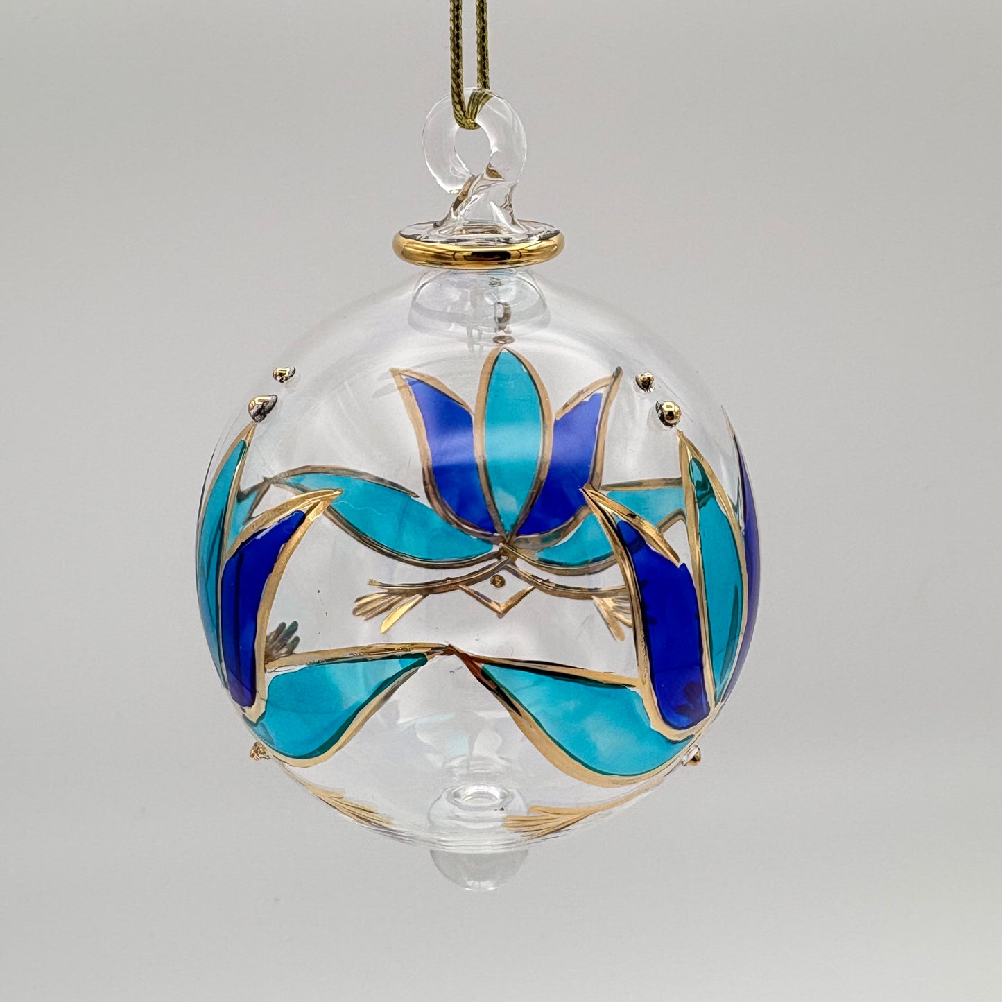 Fair trade handblown glass ornament with blue and turquoise colored lotus and gold detail, ethically handmade